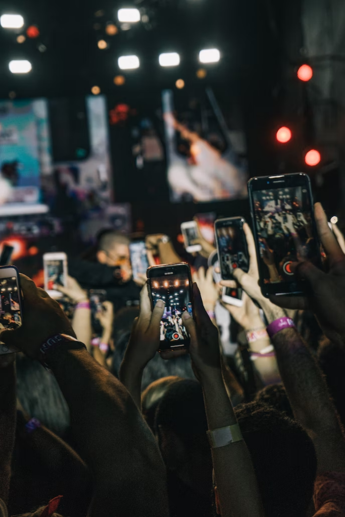 escapism & addiction - people on phones at festival